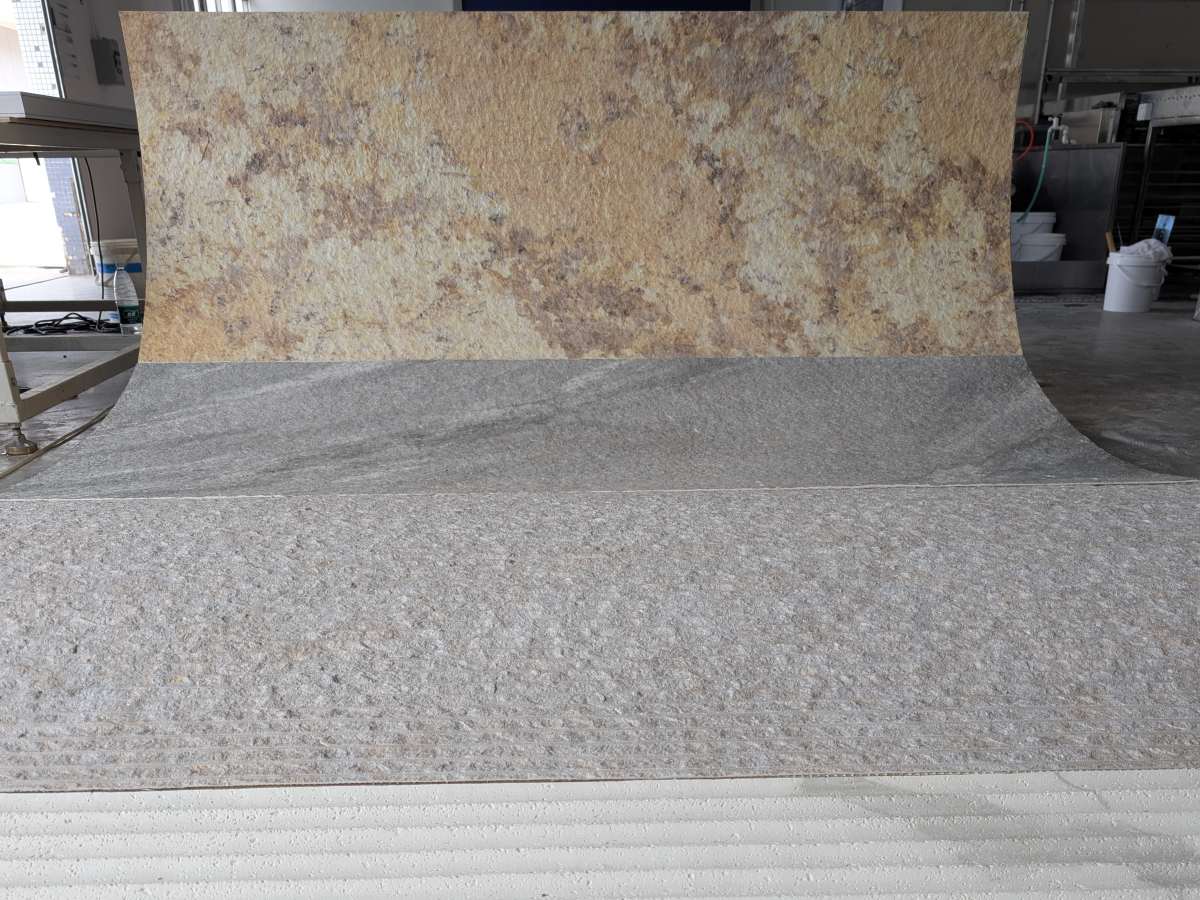 A large-format sheet of Angtai's flexible stone, highlighting its natural texture and the material's pliability.