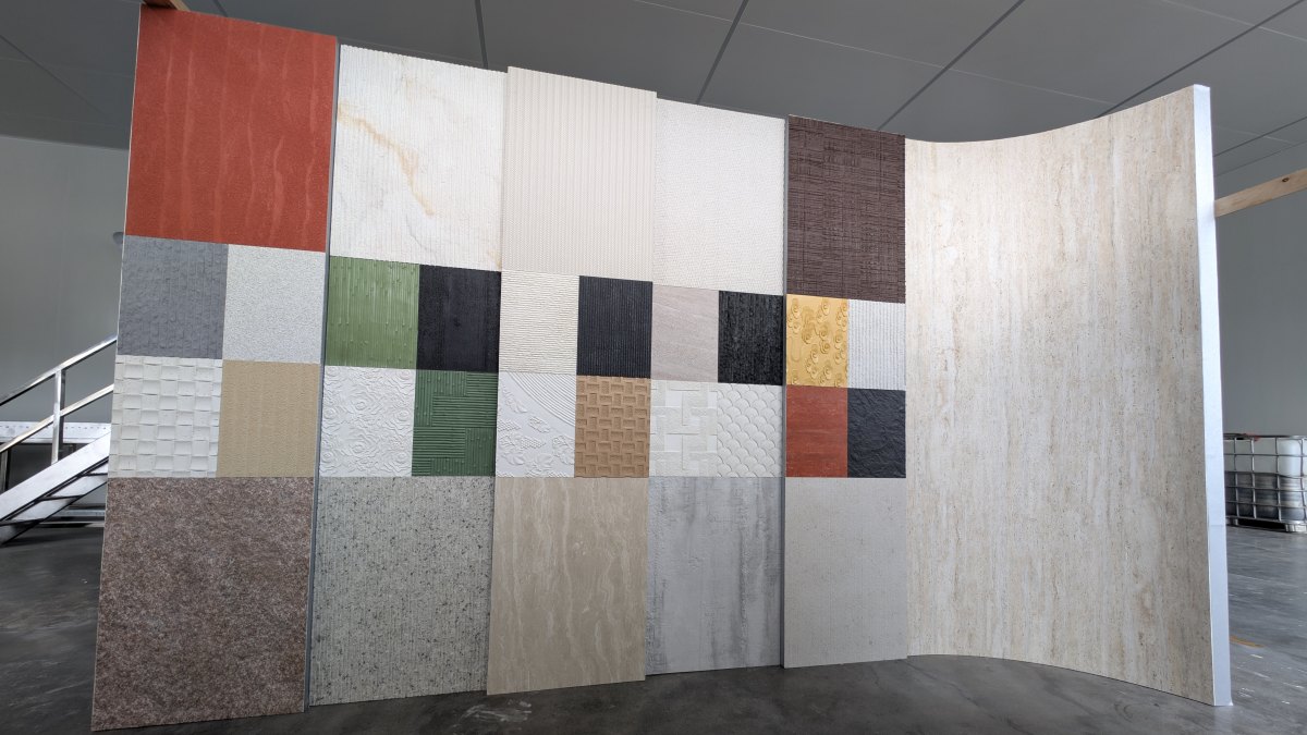 Angtai's versatile flexible stone products, in various colors and textures, are featured on a modular, curved display wall designed for Marmomac 2025.