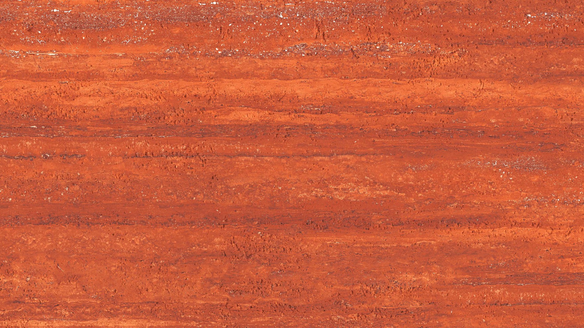 Detailed view of Angtai flexible stone in bold red and orange travertine texture.