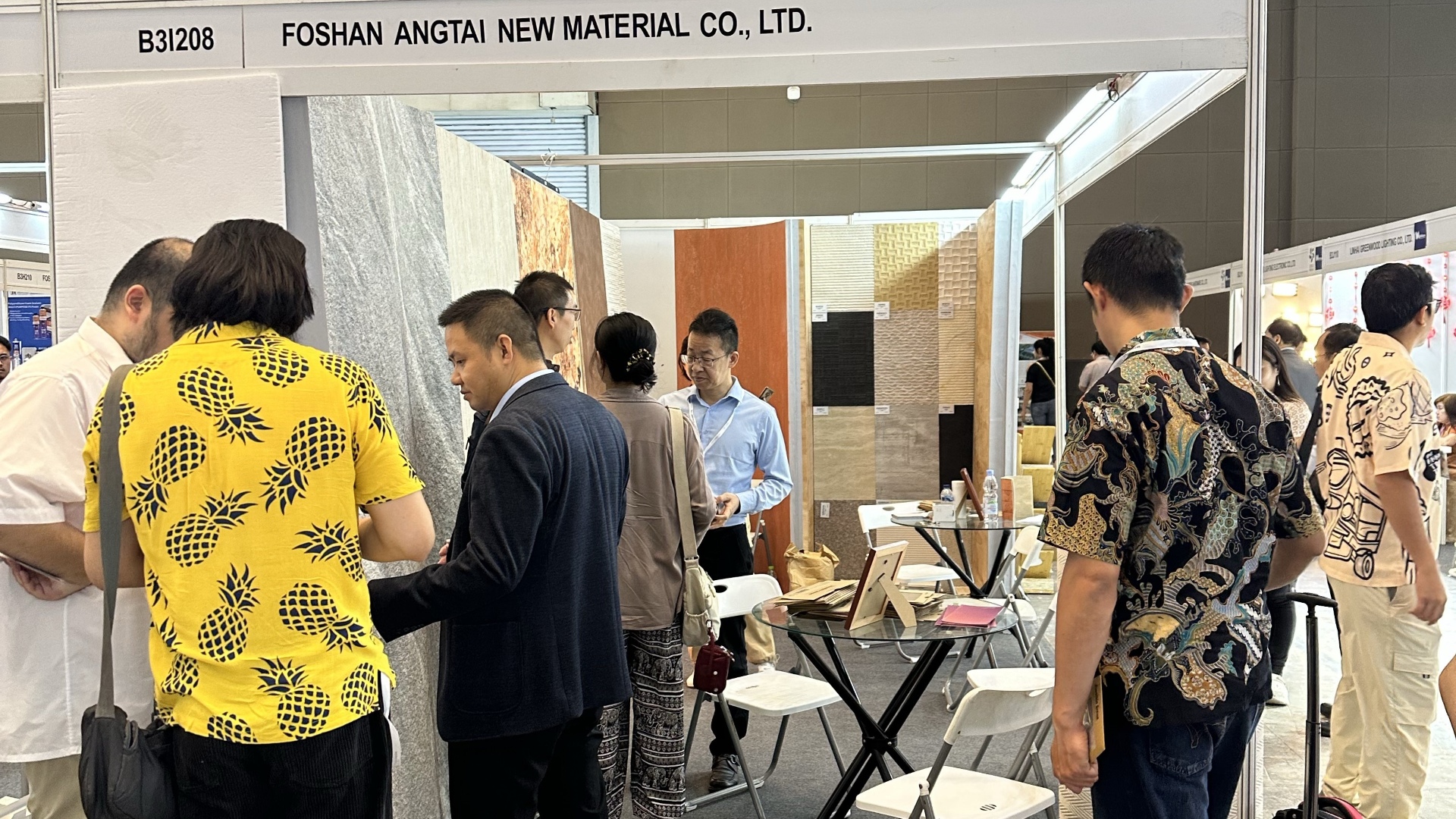 International buyers discussing MCM soft tile products directly with Angtai manufacturer representatives at Jakarta International Expo.